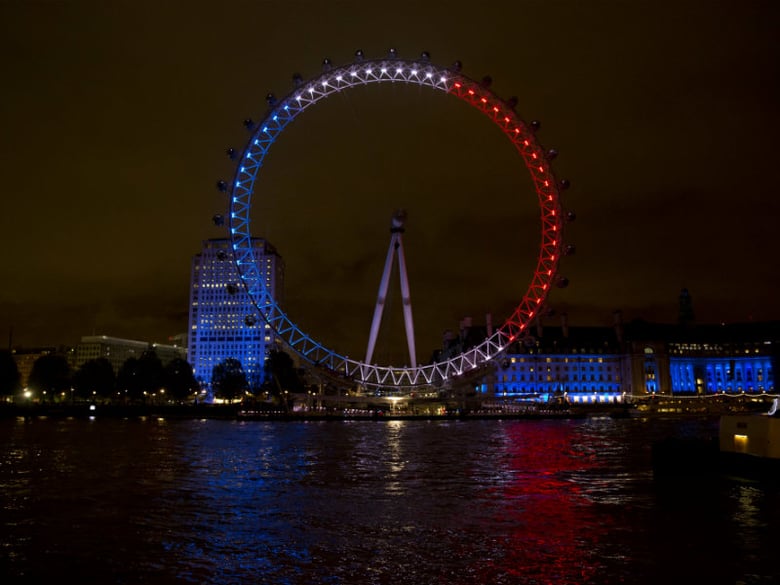 The London Eye ferris wheel is lit up in the colors of the French flag in solidarity with France after the deadly attacks in Paris, in London, Saturday, Nov. 14, 2015. 