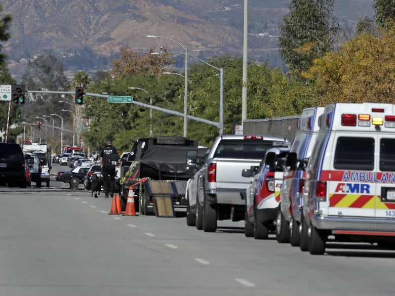 Law enforcement members line up near the the site of a mass shooting on Wednesday, Dec. 2, 2015 in San Bernardino, Calif.