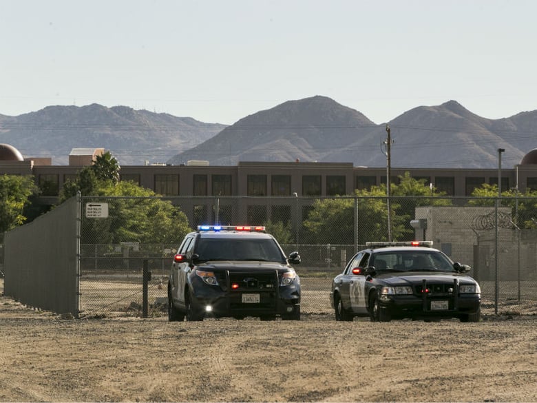 Authorities are stationed near the Inland Regional Center, Wednesday, Dec. 2, 2015, in San Bernardino, Calif. 