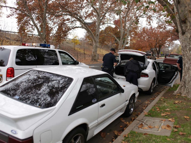 Sacramento Police Department officers conduct a search at 9th and W streets following a shooting that left a woman in critical condition.