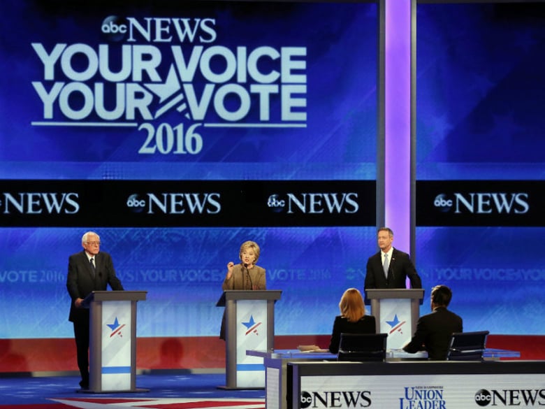 Hillary Clinton, center, speaks between Bernie Sanders, left, and Martin O’Malley during a Democratic presidential primary debate Saturday, Dec. 19, 2015, at Saint Anselm College in Manchester, N.H. 