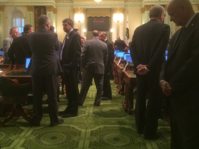 California Assembly members greet each other Monday on their first day back at the Capitol for the new year's session.