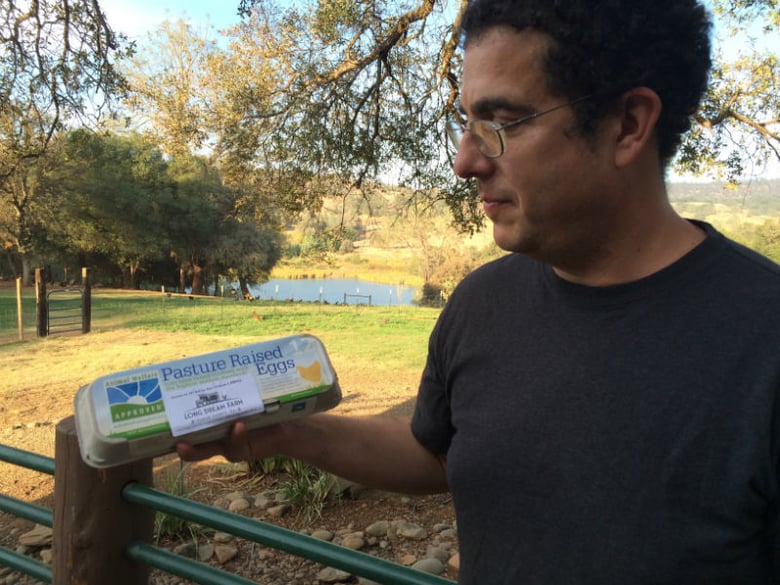 Andrew Abrahams holds a dozen animal welfare approved eggs from Long Dream Farm in Lincoln, CA. 