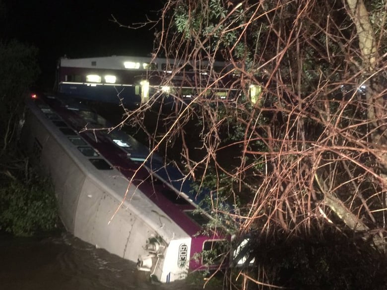 In this image provided the Alameda County Fire Department, first responders work the scene after a car of a commuter train plunged into Alameda Creek after the train derailed about 45 miles east of San Francisco. 
