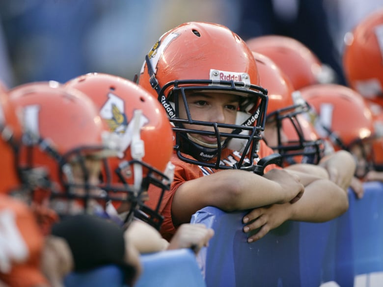 File Photo: Pop Warner football players look on before an NFL pre-season football game between the San Francisco 49ers and the San Diego Chargers Friday, Sept. 4, 2009 in San Diego.