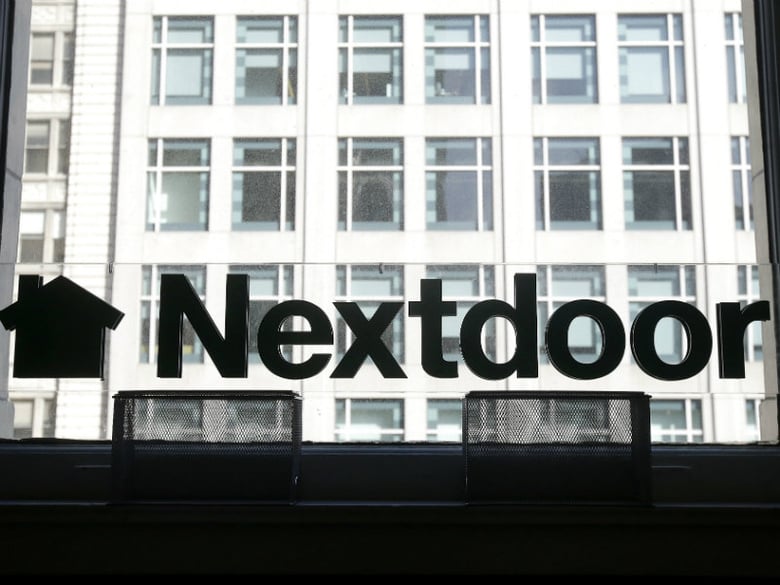 A Nextdoor sign is shown in a window at an office in San Francisco, Wednesday, May 11, 2016. 