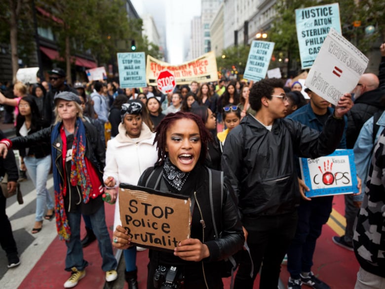 A woman, who declined to give her name, joins protesters against recent fatal shootings by police of black men, in San Francisco on Friday, July 8, 2016. The group marched about two miles to City Hall.