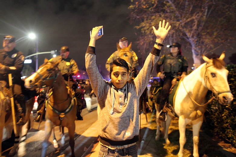 Protestors, Trump supporters and police gather outside a rally for Donald Trump at the Pacific Amphitheater in Costa Mesa on Thursday night, April 28, 2016. 