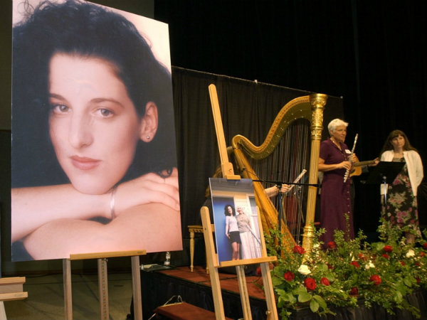 In this May 28, 2002 pool-file photo taken at the Modesto Centre Plaza in Modesto, Calif., photos of Chandra Levy are on display as musicians, right, stand by at the memorial service for Levy. 