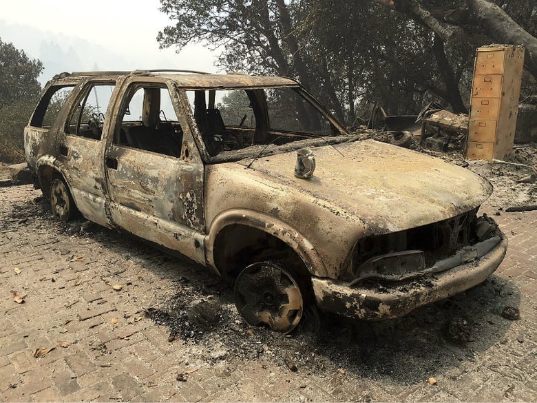 A car destroyed from wildfires sits in Big Sur, Calif., Friday, July 29, 2016. 