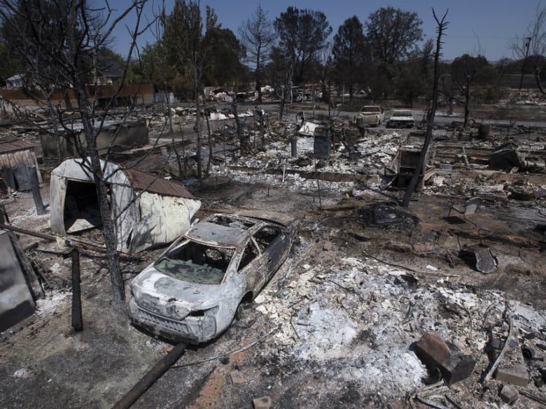 Burned properties are seen after a fire tore through a residential area in Lower Lake, Calif., Tuesday, Aug. 16, 2016.