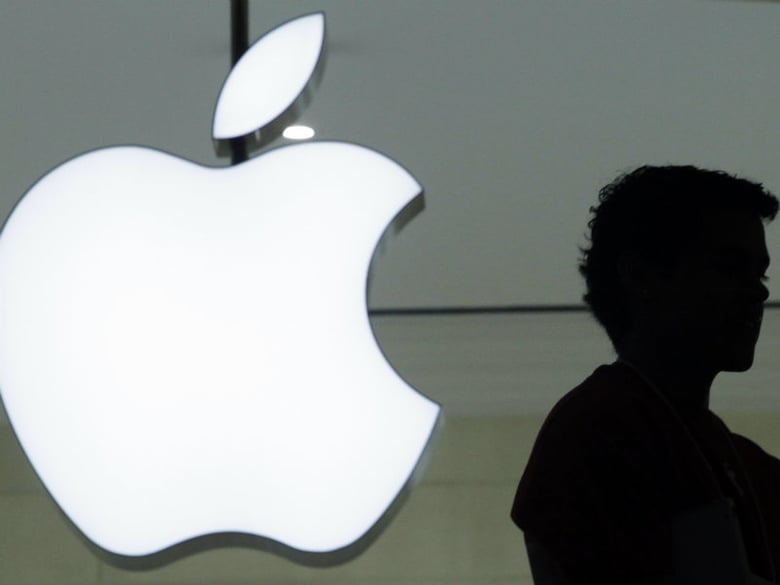 FILE - In this Wednesday, Dec. 7, 2011 file photo, a person stands near the Apple logo at the company's store in Grand Central Terminal, in New York. 