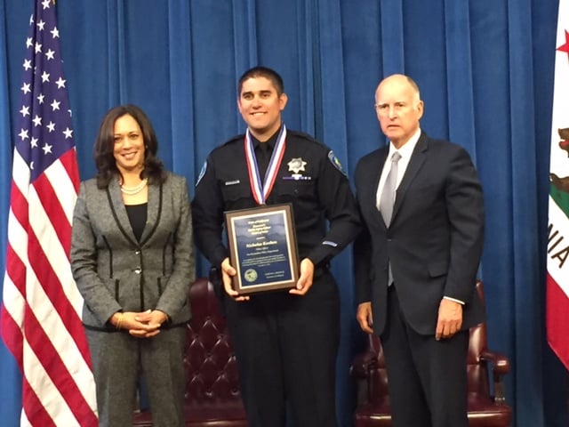 San Bernardino Police Officer Nicholas Koahou poses for a photo with Gov. Jerry Brown and Attorney General Kamala Harris after receiving the Medal of Valor in a ceremony at the state Capitol on Monday, Sept. 12, 2016.