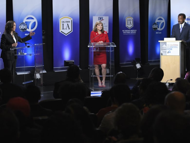 California U.S. Senate Democratic candidate California Attorney General Kamala Harris, left, speaks as Congresswoman Loretta Sanchez, center, listens along with moderator Marc Brown during a debate, Wednesday, Oct. 5, 2016, in Los Angeles.