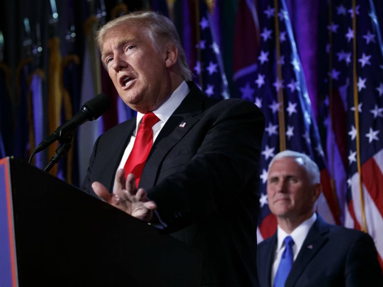 Vice president-elect Mike Pence, right, watches as President-elect Donald Trump speaks during an election night rally, Wednesday, Nov. 9, 2016, in New York. 
