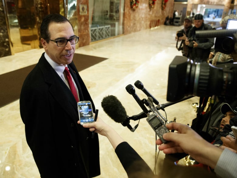 Steven Mnuchin, President-elect Donald Trump's nominee for Treasury Secretary, talks with reporters in the lobby of Trump Tower, Wednesday, Nov. 30, 2016, in New York.