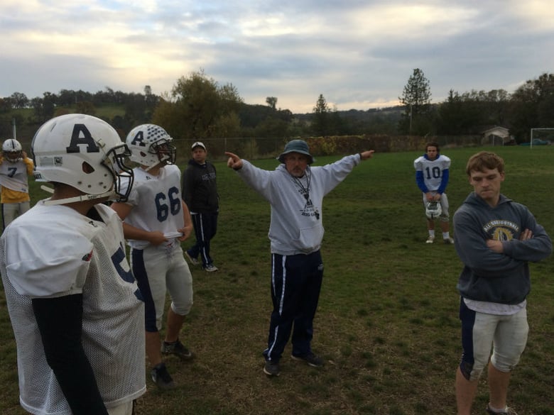 Amador Head Coach Bill Baker lays out the game plan for his players as the school prepares for this Saturday's northern California championship playoff game in San Francisco. 