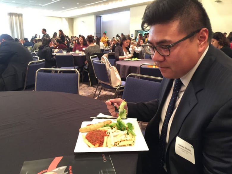 Andrew Medina with Asian Americans Advancing Justice looks over the conference program Wednesday just before the event’s lunch plenary discussion: “What’s At Stake After The Elections”
