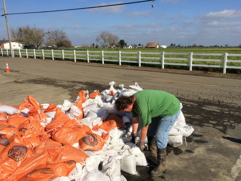 Bridget Lasso loads up her trailer with sand bags. She says her boss' home was an inch away from flooding last week.