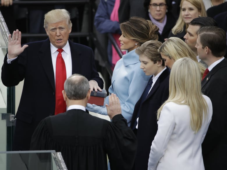 Donald Trump is sworn in as the 45th president of the United States by Chief Justice John Roberts as Melania Trump looks on during the 58th Presidential Inauguration at the U.S. Capitol in Washington, Friday, Jan. 20, 2017.

