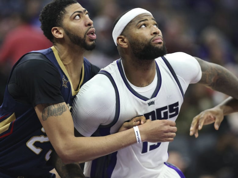 Sacramento Kings center DeMarcus Cousins (15) and New Orleans Pelicans center Anthony Davis (23) battle for position under the basket during the second half of an NBA basketball game in Sacramento, Calif., Sunday, Feb. 12, 2017.