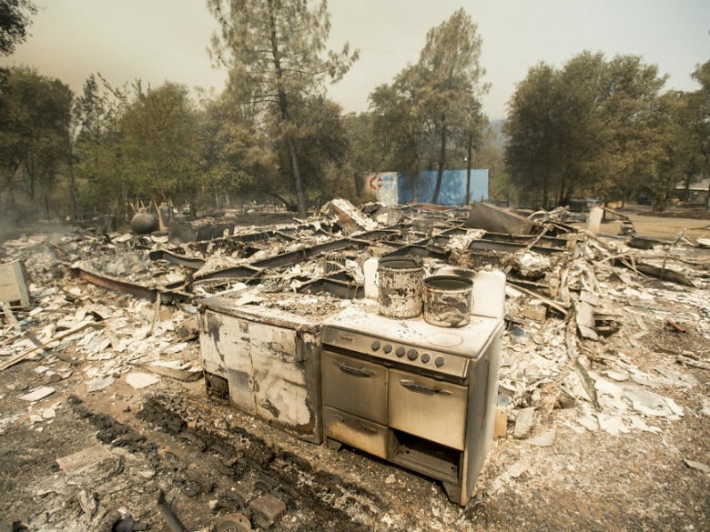 A stove stands in front of a structure leveled by a wildfire near Oroville, Calif., on Saturday, July 8, 2017. Residents were ordered to evacuate from several roads in the rural area as flames climbed tall trees. 

