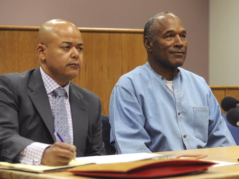 Former NFL football star O.J. Simpson appears with his attorney, Malcolm LaVergne, left, via video for his parole hearing at the Lovelock Correctional Center in Lovelock, Nev., on Thursday, July 20, 2017.