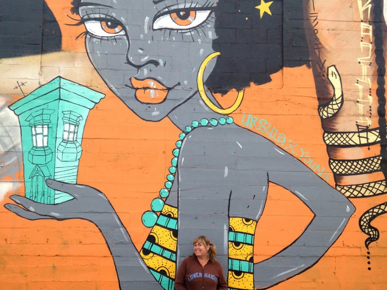 Ursula X. Young's Standing In Front Of Her Mural In Oakland / Courtesy