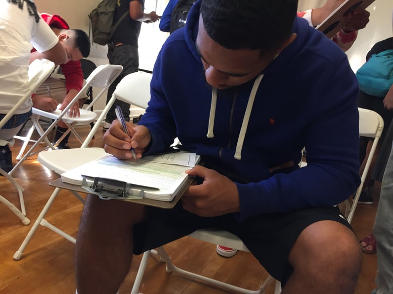 Grant Union High School senior James Fotofini fills out a voter registration form on National Voter Registration Day, Tuesday, September 26, 2017.
