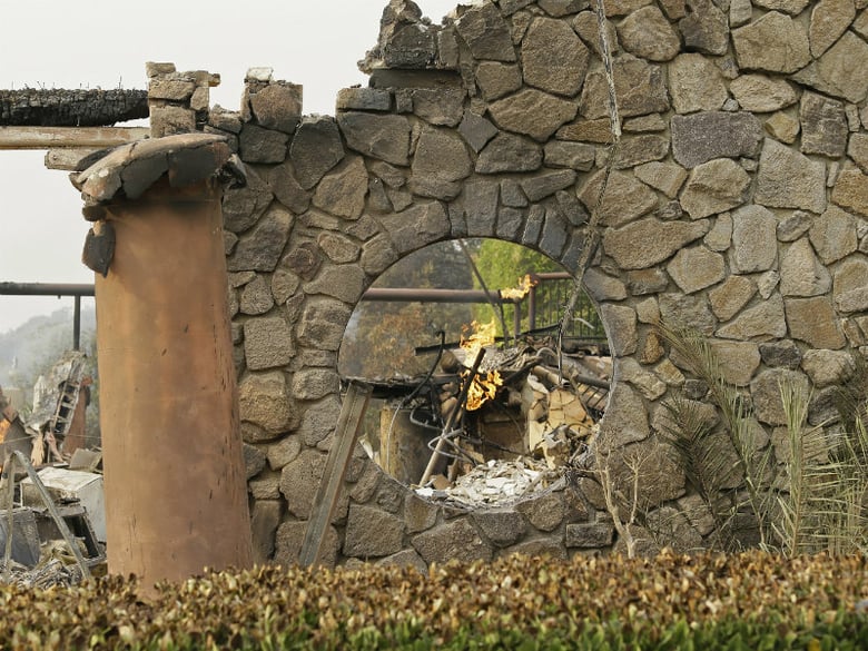 Flames continue to smolder at the Signorello Estate winery Tuesday, Oct. 10, 2017, in Napa, Calif. 