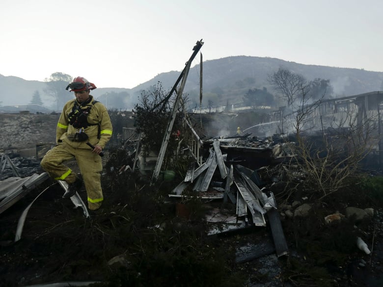 Fire crews search for hot spots among destroyed homes in the Rancho Monserate Country Club community Friday, Dec. 8, 2017, in Fallbrook, Calif.