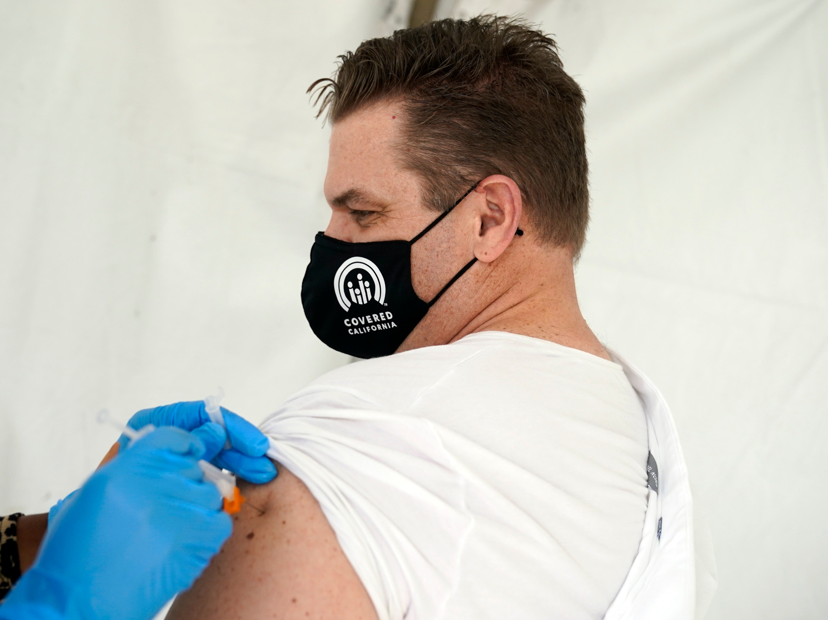 https://www.capradio.org/media/12257105/021221_covered-california-mask-vaccinate-shot-p.jpg