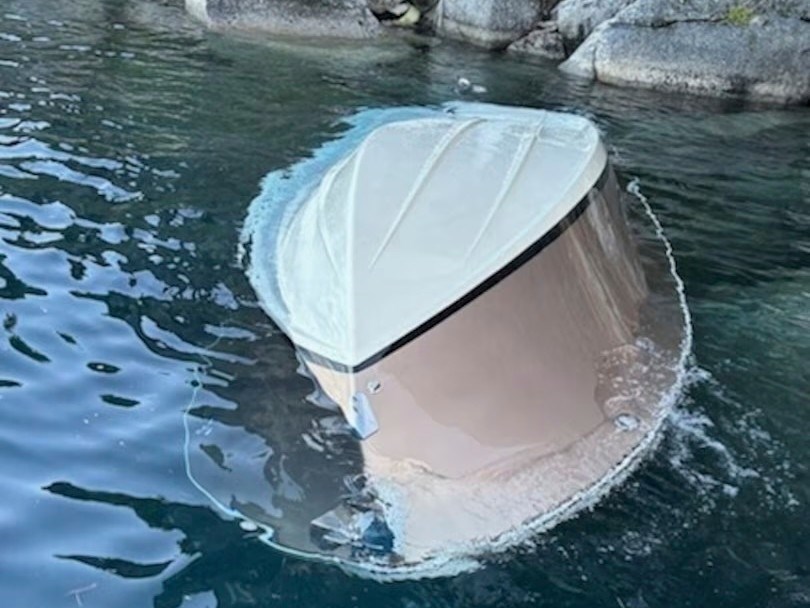 In the photo released by the U.S. Coast Guard, a capsized vessel floats is seen near D.L. Bliss State Park at Lake Tahoe, Calif., June 21, 2025.