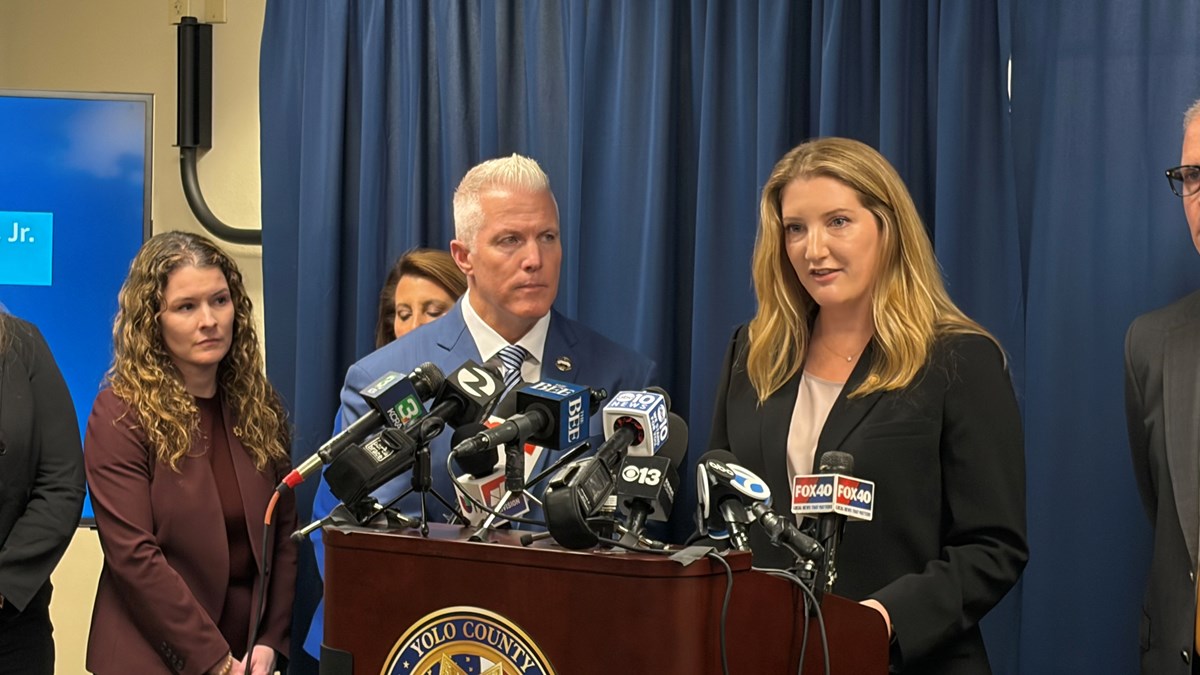 Yolo County Deputy District Attorney Clara Nabity (right) and District Attorney Jeff Reisig (center) speak at a news conference Friday, April 10, 2026, in Woodland, Calif., to announce indictments in connection with the July 2025 Esparto explosion.