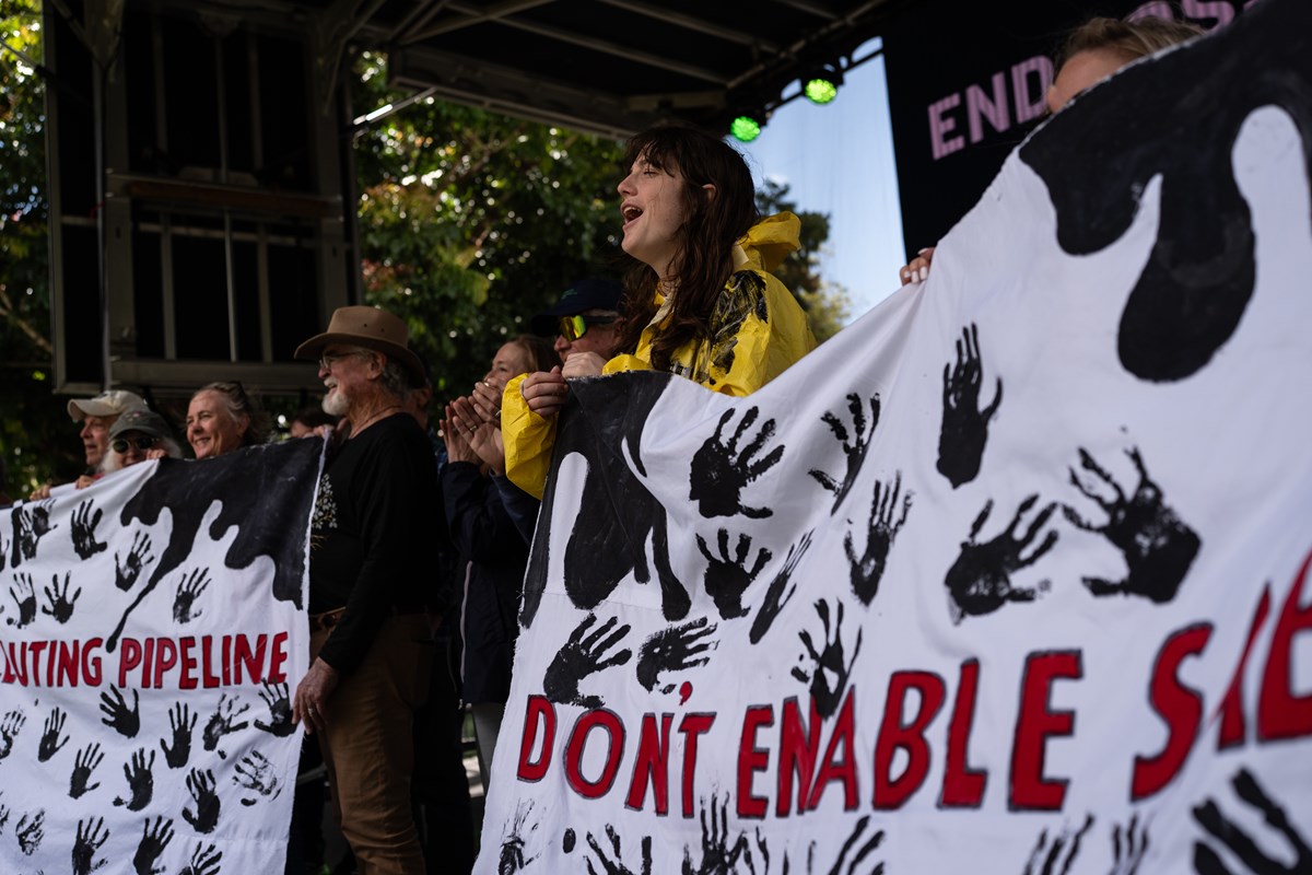Activists opposing Sable Offshore Corp.'s offshore oil operations hold banners during the Santa Barbara Earth Day Festival in Santa Barbara, Calif., Sunday, April 26, 2026.