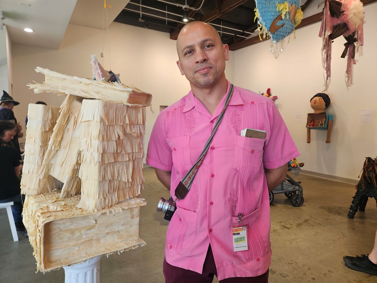 Andres Alvarez&rsquo;s pi&ntilde;ata is titled &ldquo;In ixtli, in yollotl&rdquo; (the face, the heart.) It features a stack of books, representing works by Latino and Chicano authors, wrapped in hojas de maiz (corn husks) as a symbol of culture.