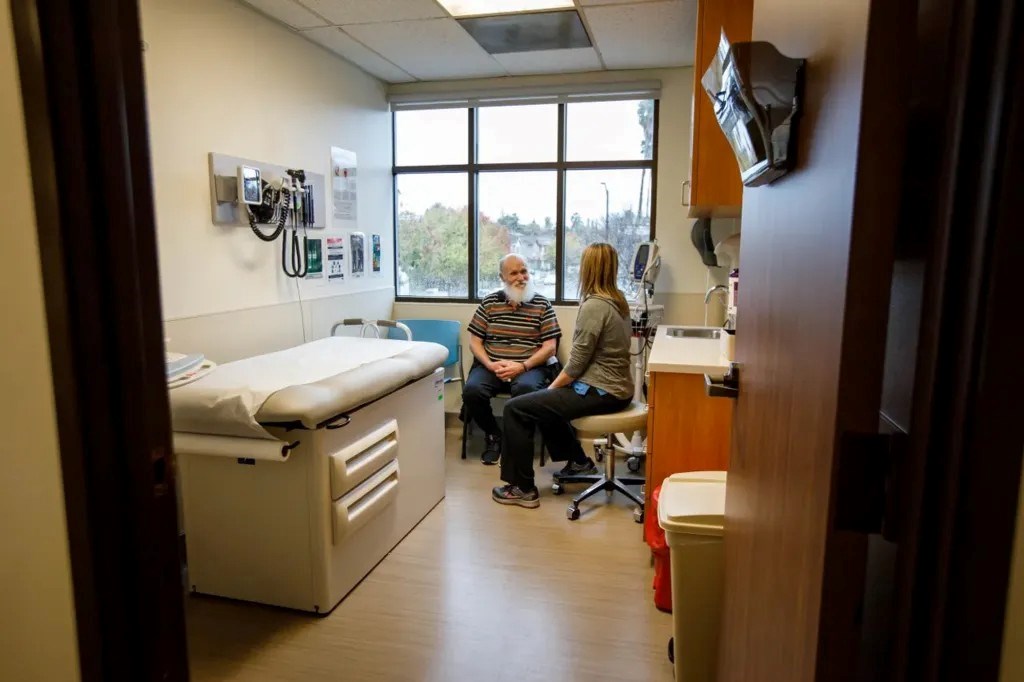 From left, David Webb talks to Christy McCurdy, a registered nurse, at Hope Clinic in San Jose on Dec. 2, 2019. The clinic provides assistance such as addiction treatment and monitoring chronic conditions to formerly homeless.
