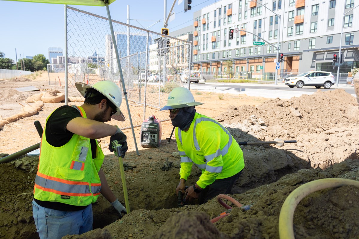 Construction workers Abel Mu&ntilde;oz (left) and Carlos Barrera putting in optic fiber for the Republic FC Stadium Tuesday, July 14, 2026, in the Sacramento Railyards.