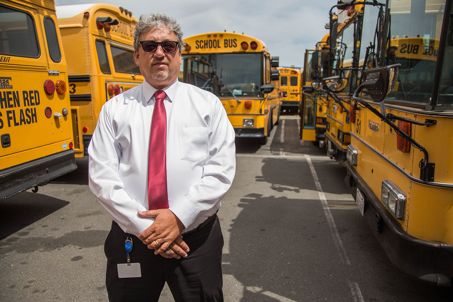 Twin Rivers Unified School District Director of Transportation, Tim Shannon, stands among the desitrict's fleet of primarily diesel school buses. 
